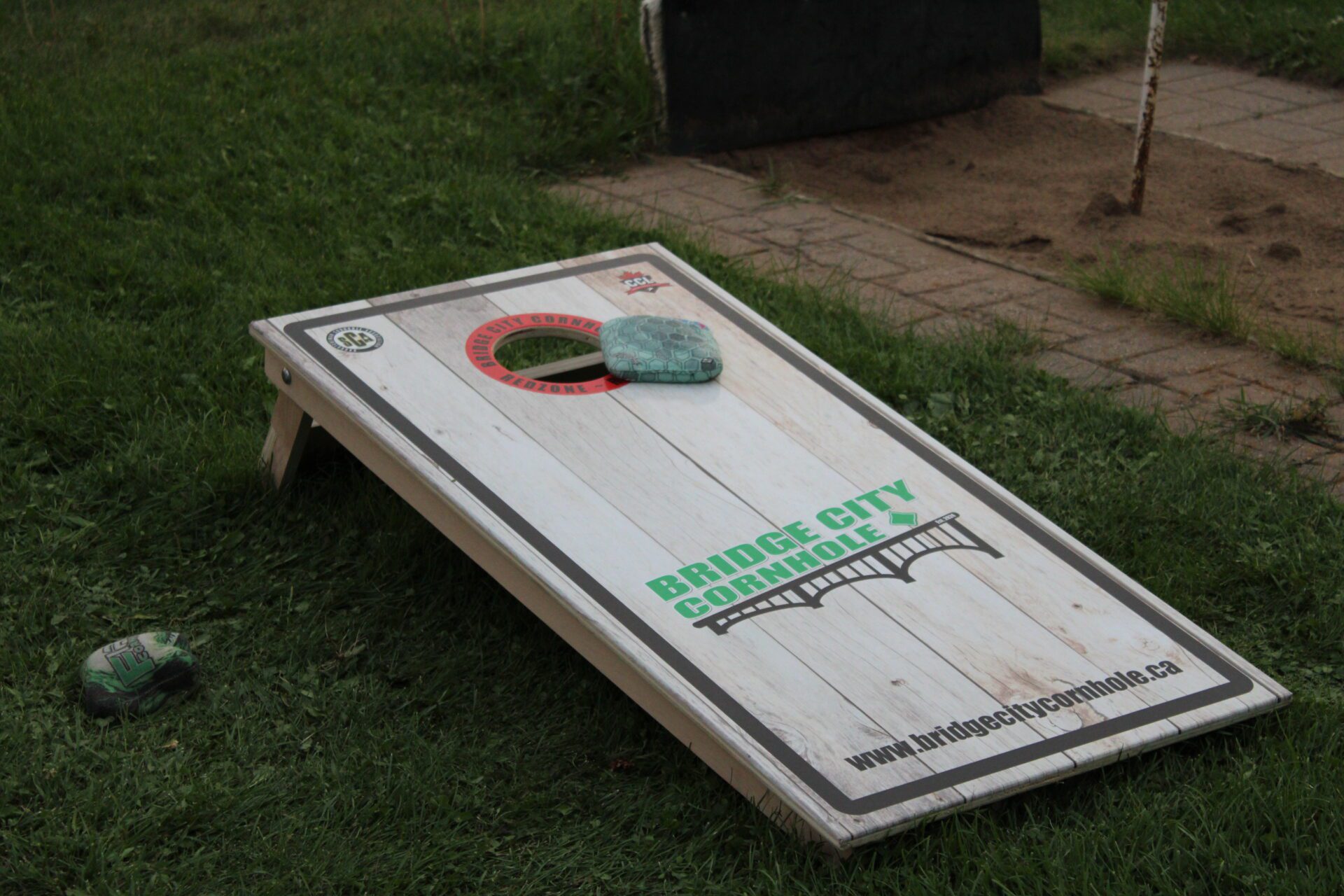 playing cornhole in backyard